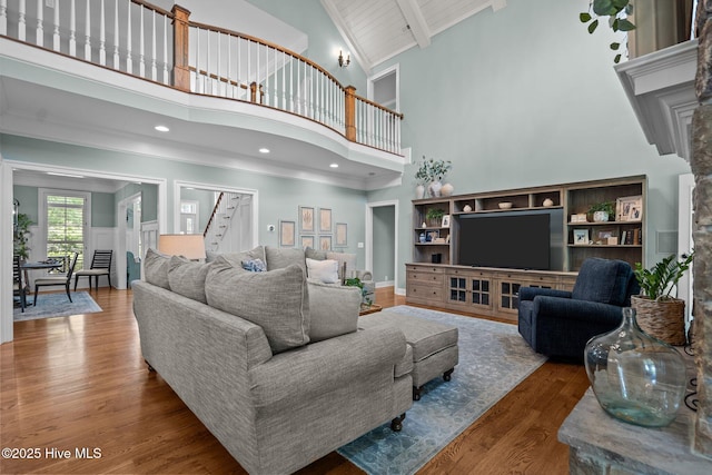 3681 Fairfield Way, Southport, NC 28461 - living room featuring high vaulted ceiling, wood finished floors, beamed ceiling, and stairs