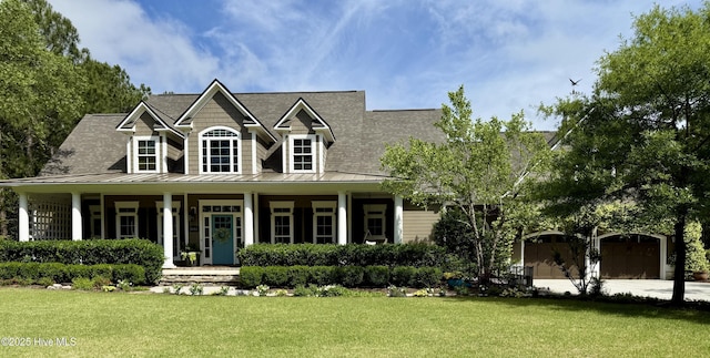 view of front of property featuring roof with shingles, a front lawn, a standing seam roof, covered porch, and metal roof