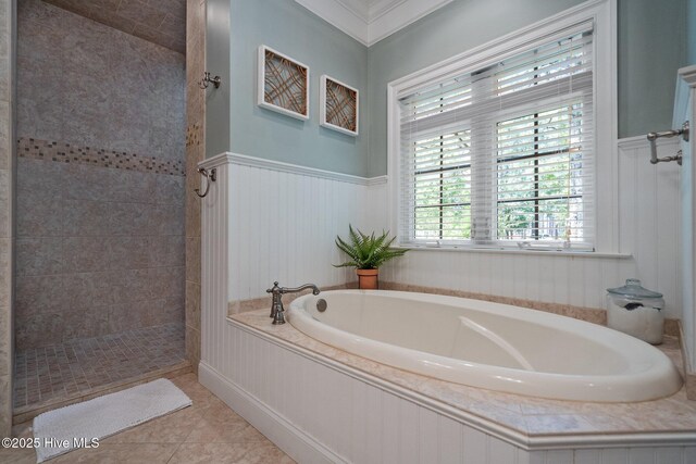 3681 Fairfield Way, Southport, NC 28461 - full bathroom featuring a garden tub, a tile shower, tile patterned flooring, wainscoting, and ornamental molding