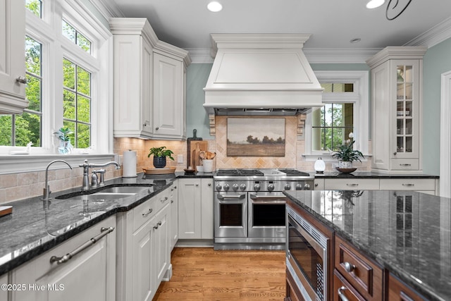 3681 Fairfield Way, Southport, NC 28461 - kitchen with appliances with stainless steel finishes, healthy amount of natural light, crown molding, custom range hood, and white cabinets