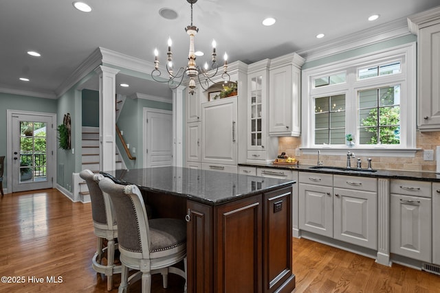 3681 Fairfield Way, Southport, NC 28461 - kitchen featuring recessed lighting, a center island, light wood-type flooring, white cabinetry, and decorative backsplash