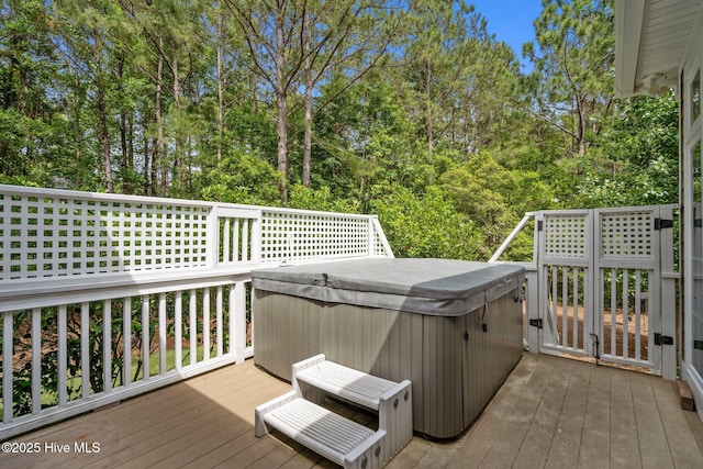 3681 Fairfield Way, Southport, NC 28461 - deck featuring a hot tub and view of wooded area