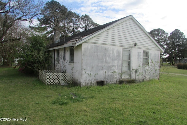 view of side of property with a yard