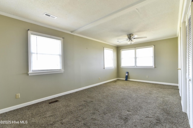 unfurnished room with ceiling fan, ornamental molding, a textured ceiling, and visible vents