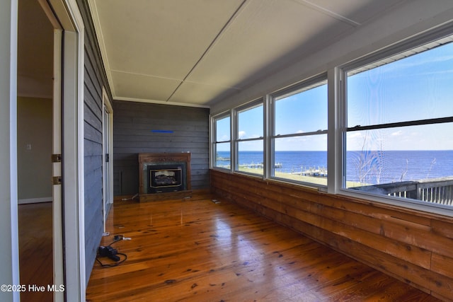 unfurnished sunroom with a water view