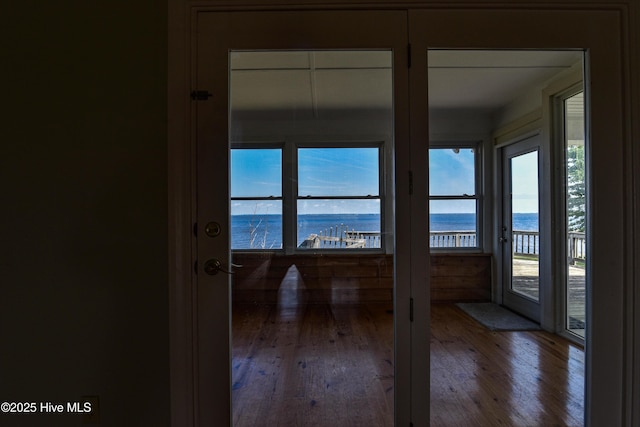 doorway featuring a water view and hardwood / wood-style flooring