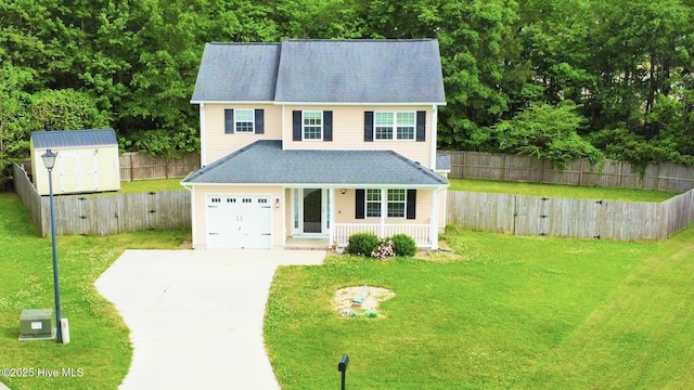 traditional-style home with covered porch, driveway, a front yard, a storage shed, and a fenced backyard