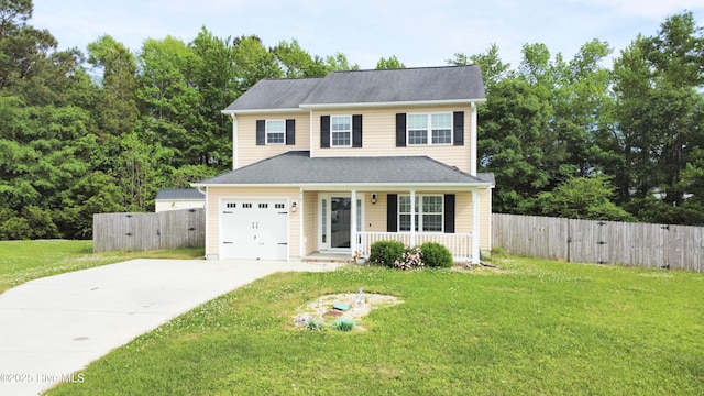 traditional-style house featuring a porch, fence, driveway, and a front yard