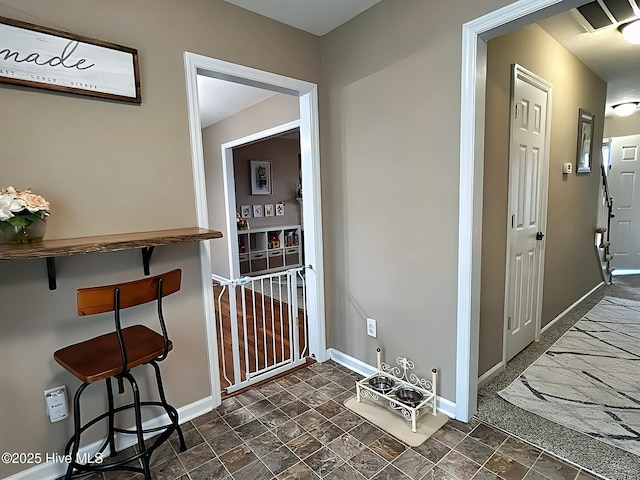 interior space featuring baseboards and stone finish floor