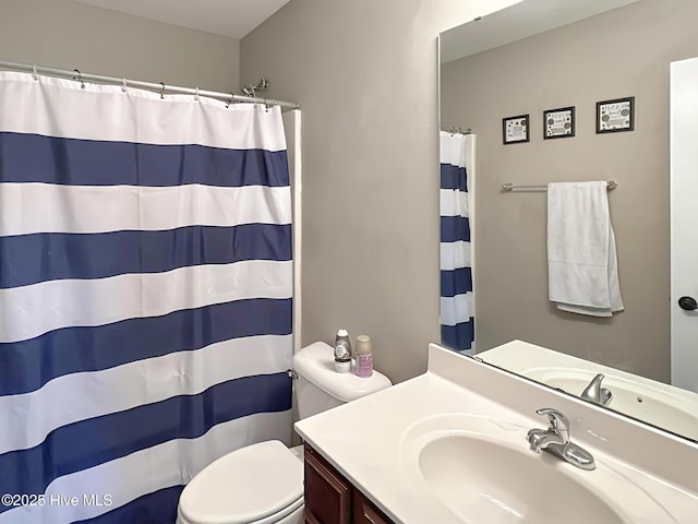bathroom featuring vanity, a shower with shower curtain, and toilet