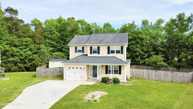 traditional home with covered porch, fence, driveway, and a front lawn