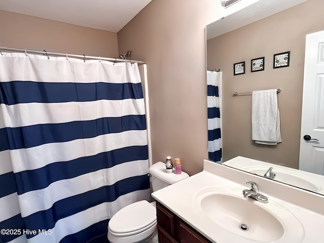 bathroom featuring vanity, a shower with shower curtain, and toilet
