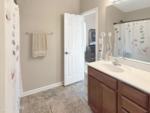 bathroom with baseboards and vanity