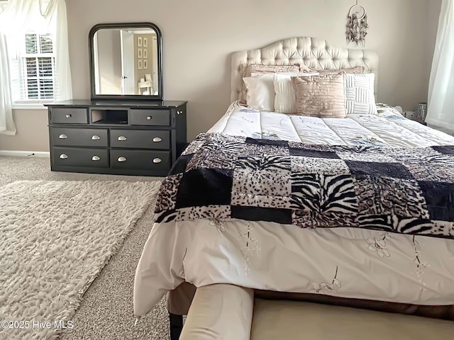 carpeted bedroom featuring baseboards