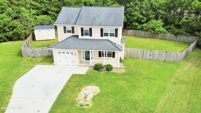 traditional-style home featuring a storage unit, concrete driveway, a porch, and a front lawn