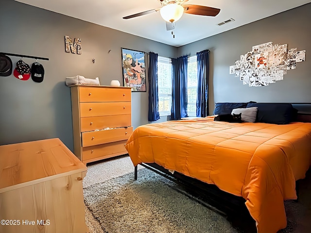 carpeted bedroom with ceiling fan and visible vents