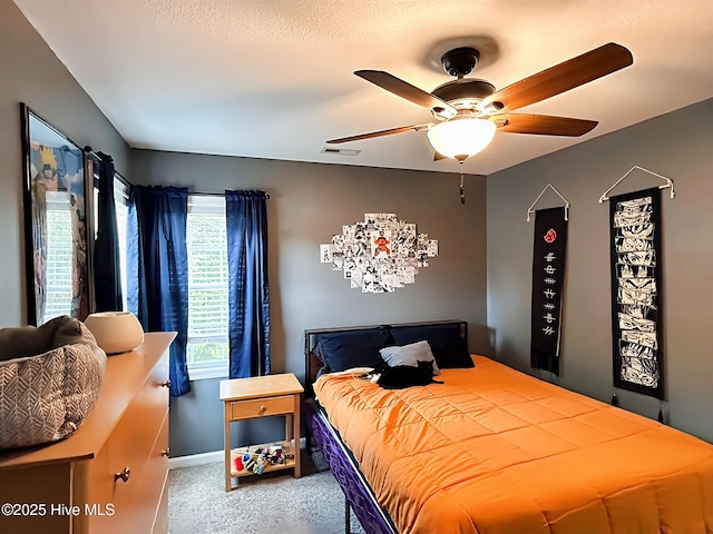 carpeted bedroom featuring baseboards, visible vents, and ceiling fan