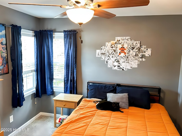carpeted bedroom with baseboards and ceiling fan