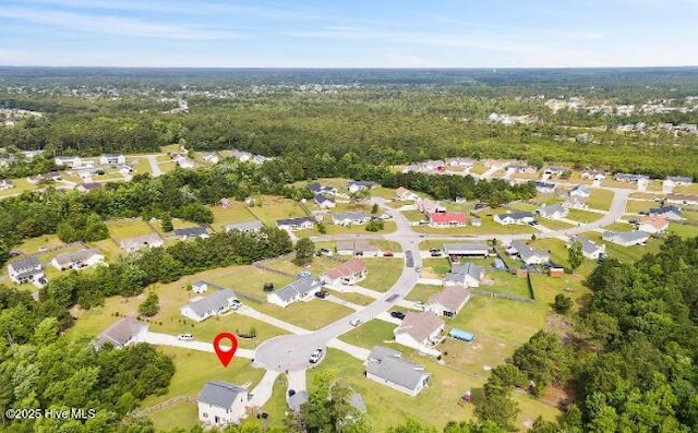 birds eye view of property with a residential view and a forest view