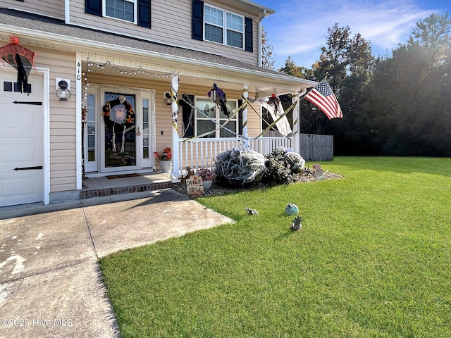 doorway to property with a lawn and covered porch