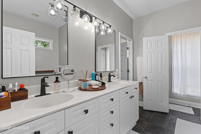 bathroom with a sink, tile patterned flooring, and double vanity