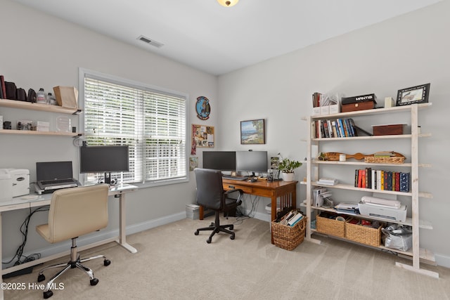 carpeted office space featuring visible vents and baseboards