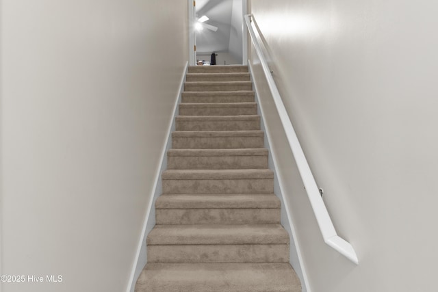 stairway featuring carpet flooring and baseboards