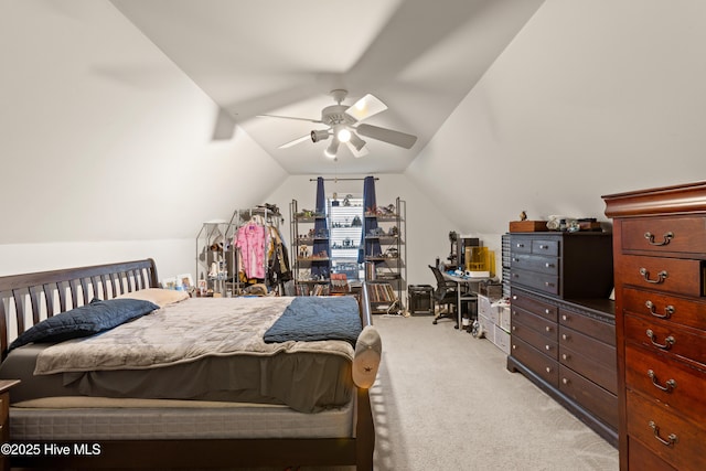 bedroom featuring a ceiling fan, light colored carpet, and vaulted ceiling