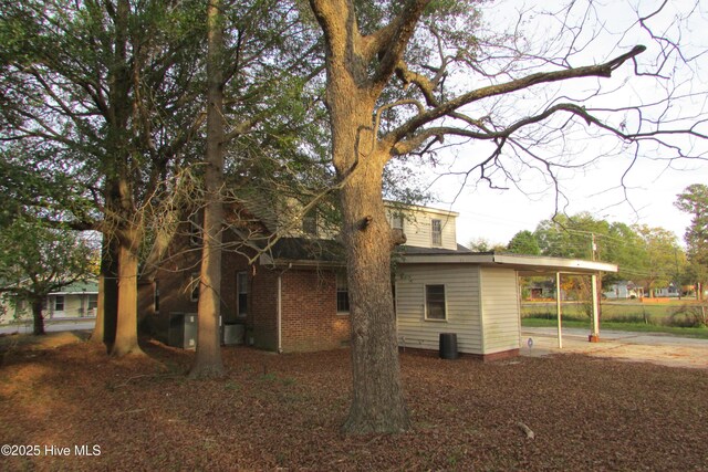 803 Mccoy St, Clinton, NC 28328 - rear view of house with an attached carport