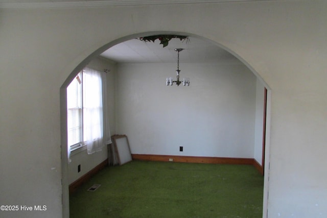 803 Mccoy St, Clinton, NC 28328 - unfurnished dining area featuring arched walkways, carpet, a chandelier, and a wealth of natural light