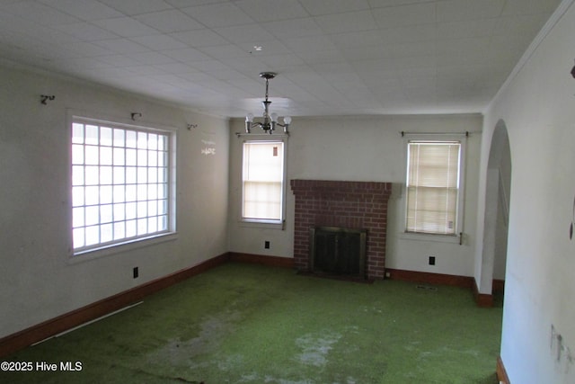 803 Mccoy St, Clinton, NC 28328 - unfurnished living room with baseboards, carpet flooring, a brick fireplace, and arched walkways