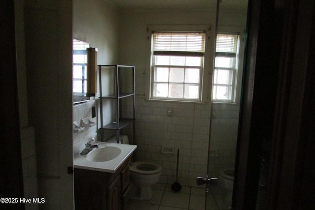 803 Mccoy St, Clinton, NC 28328 - full bathroom featuring vanity, tile patterned floors, toilet, and tile walls