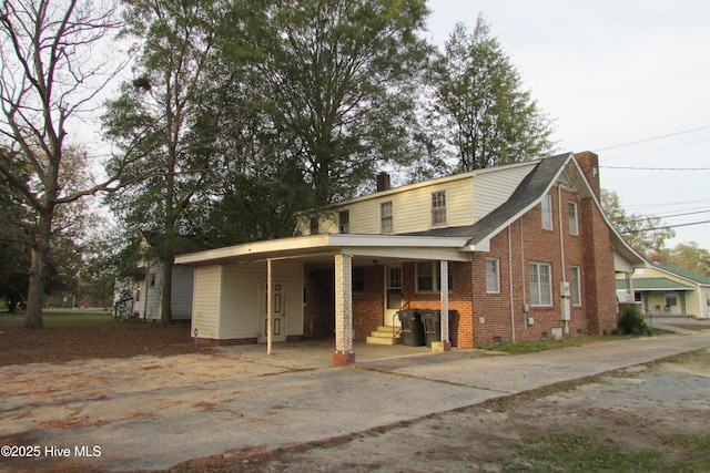 803 Mccoy St, Clinton, NC 28328 - exterior space featuring an attached carport, concrete driveway, and brick siding