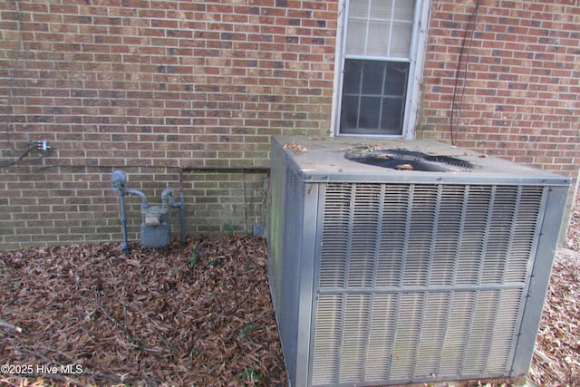 803 Mccoy St, Clinton, NC 28328 - details with brick siding, central AC, and gas meter
