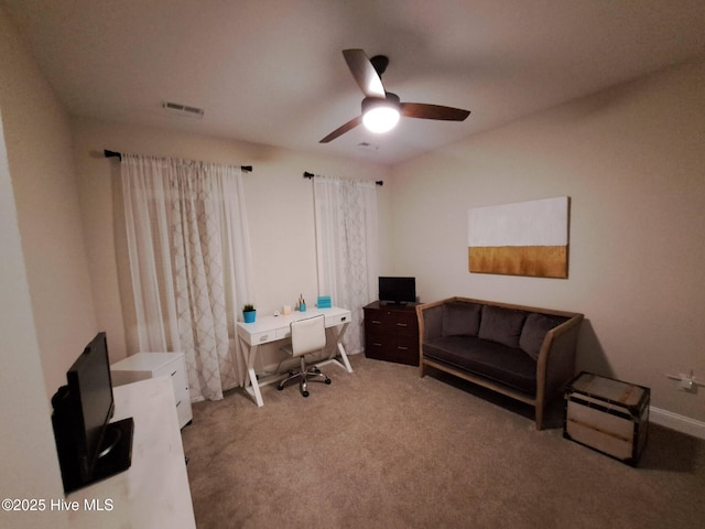 office featuring carpet flooring, a ceiling fan, and visible vents