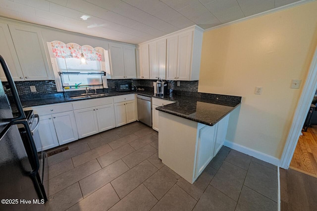 465 Meadstown Rd, Elizabeth City, NC 27909 - kitchen featuring backsplash, stainless steel dishwasher, a sink, white cabinets, and a peninsula