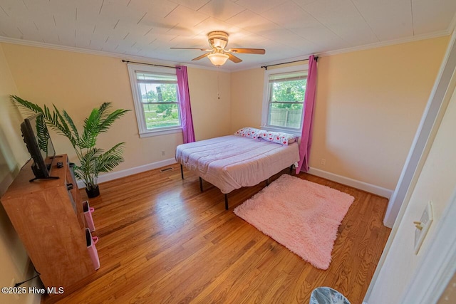 465 Meadstown Rd, Elizabeth City, NC 27909 - bedroom with crown molding, baseboards, ceiling fan, and light wood-type flooring