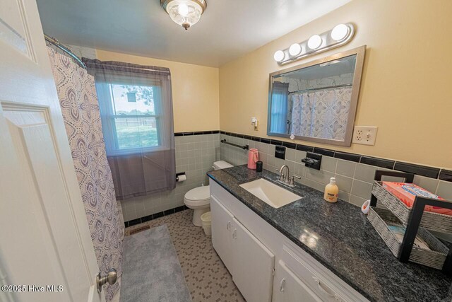 465 Meadstown Rd, Elizabeth City, NC 27909 - bathroom featuring wainscoting, vanity, toilet, a shower with shower curtain, and tile walls