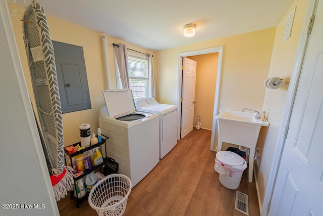 465 Meadstown Rd, Elizabeth City, NC 27909 - laundry room featuring washer and dryer, laundry area, light wood-type flooring, visible vents, and electric panel