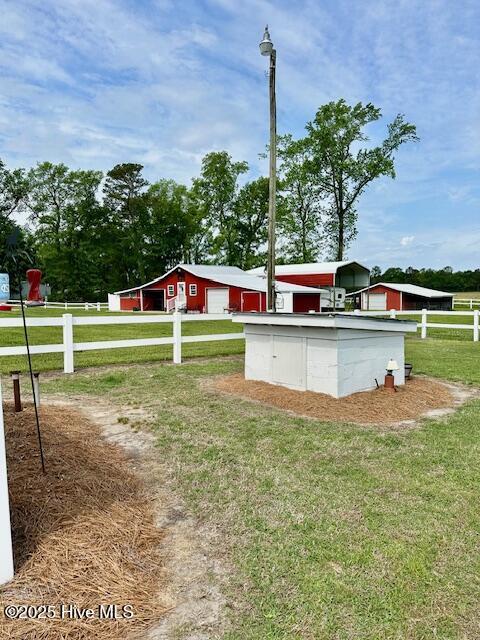 view of yard with fence and a garage