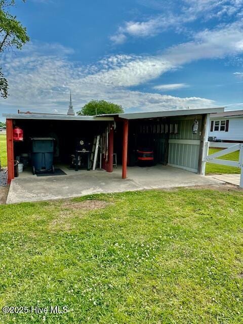 view of pole building with a carport and a yard