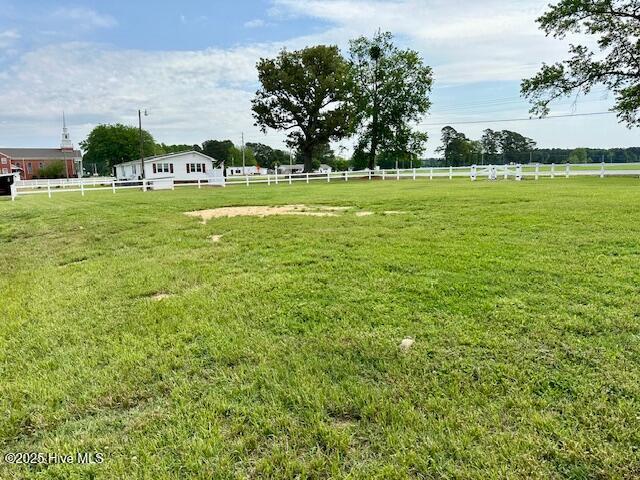 view of yard with a rural view and fence