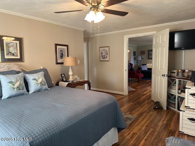 bedroom with ornamental molding, baseboards, dark wood-type flooring, a textured ceiling, and a ceiling fan
