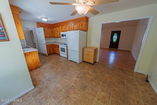 146 Ranch Dr, Elizabeth City, NC 27909 - kitchen with ceiling fan, white appliances, light countertops, baseboards, and light floors