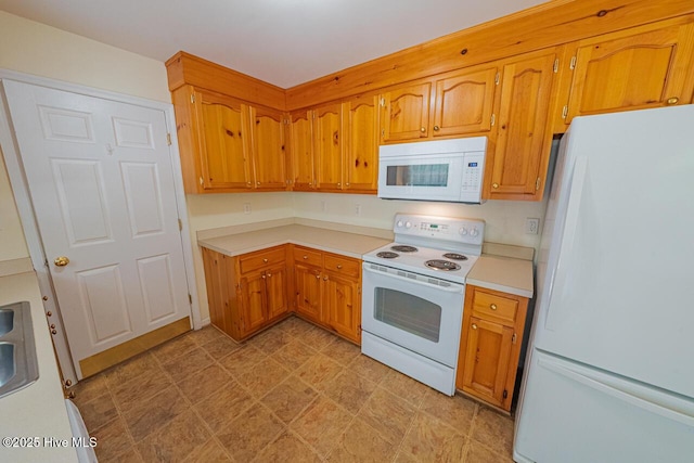 146 Ranch Dr, Elizabeth City, NC 27909 - kitchen featuring brown cabinetry, light countertops, light floors, and white appliances