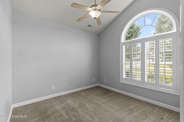 unfurnished room featuring carpet flooring, baseboards, visible vents, and vaulted ceiling