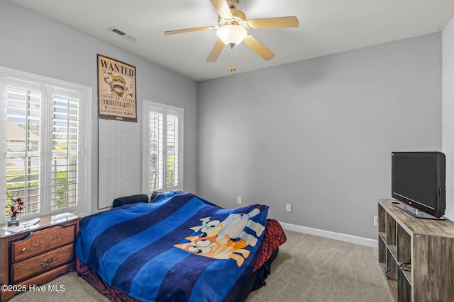 bedroom featuring baseboards, ceiling fan, light carpet, and visible vents