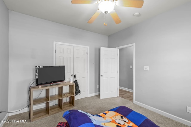 carpeted bedroom featuring baseboards, ceiling fan, and a closet