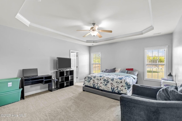 bedroom with visible vents, a raised ceiling, carpet floors, and multiple windows