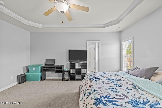 bedroom with baseboards, ornamental molding, a raised ceiling, and carpet